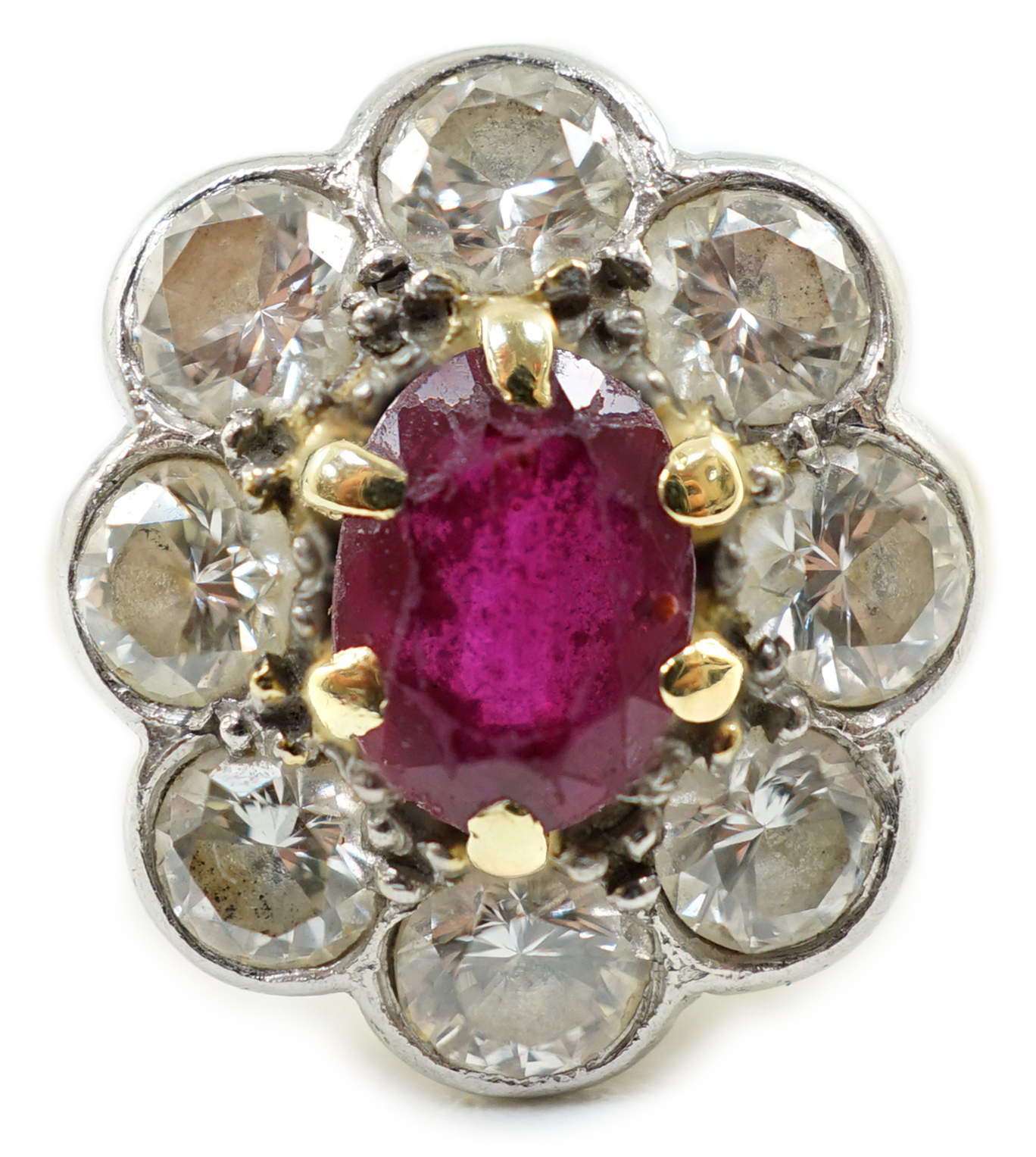 An 18ct gold, claw set single stone ruby and eight stone collet set diamond oval cluster ring